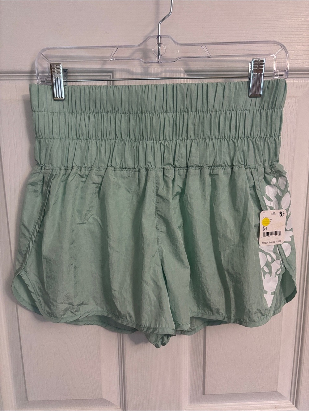 FP Movement High-Waist Light Green Athletic Shorts with Smocked Waistband.